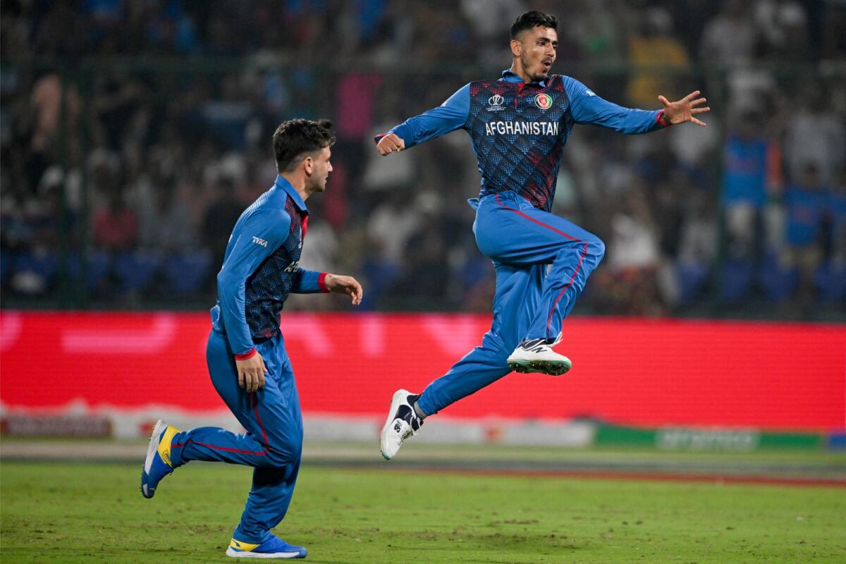 Afghanistan's Mujeeb Ur Rahman (right) celebrates after taking the wicket of England's Harry Brook. — AFP