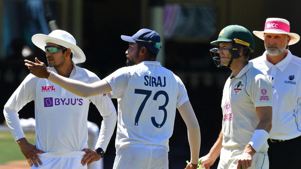 India's Mohammed Siraj (centre) gestures as  Australia's captain Tim Paine looks on. The game was halted after some spectators allegedly made racist remarks on the fourth day of the third Test at the Sydney Cricket Ground. (AFP)