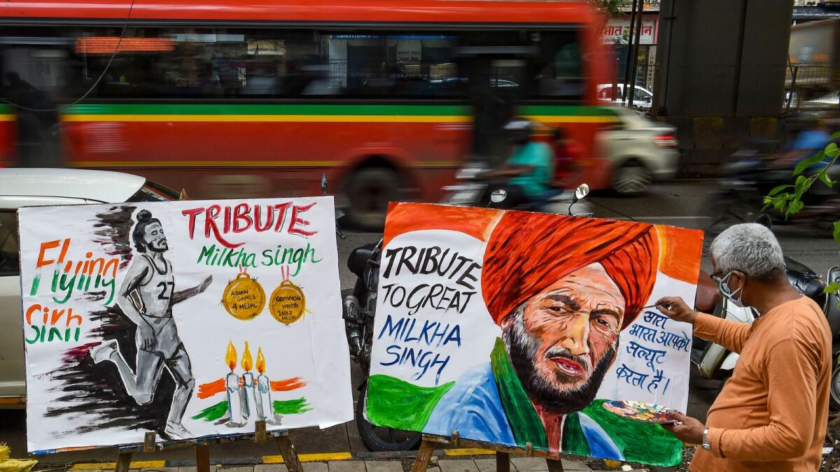 An art teacher draws a painting of Indian athelete Milkha Singh as a tribute after he died following post Covid complications. — PTI