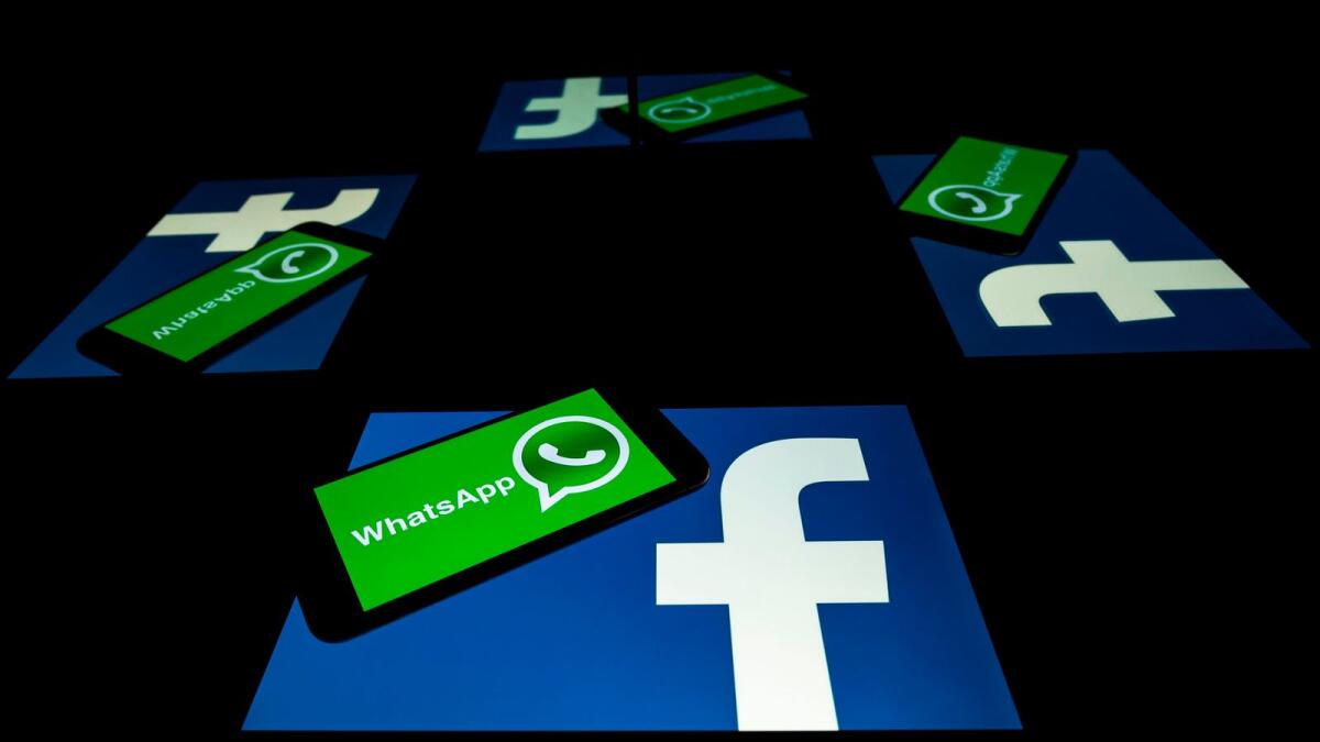 The logo of US social network Facebook and mobile messaging service WhatsApp on the screens of a smartphone and a tablet in Toulouse, southwestern France. — AFP