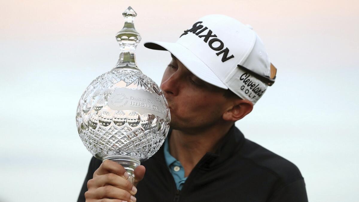 John Catlin celebrates with the trophy after winning the Irish Open at Galgorm Castle Golf Club. (AP)