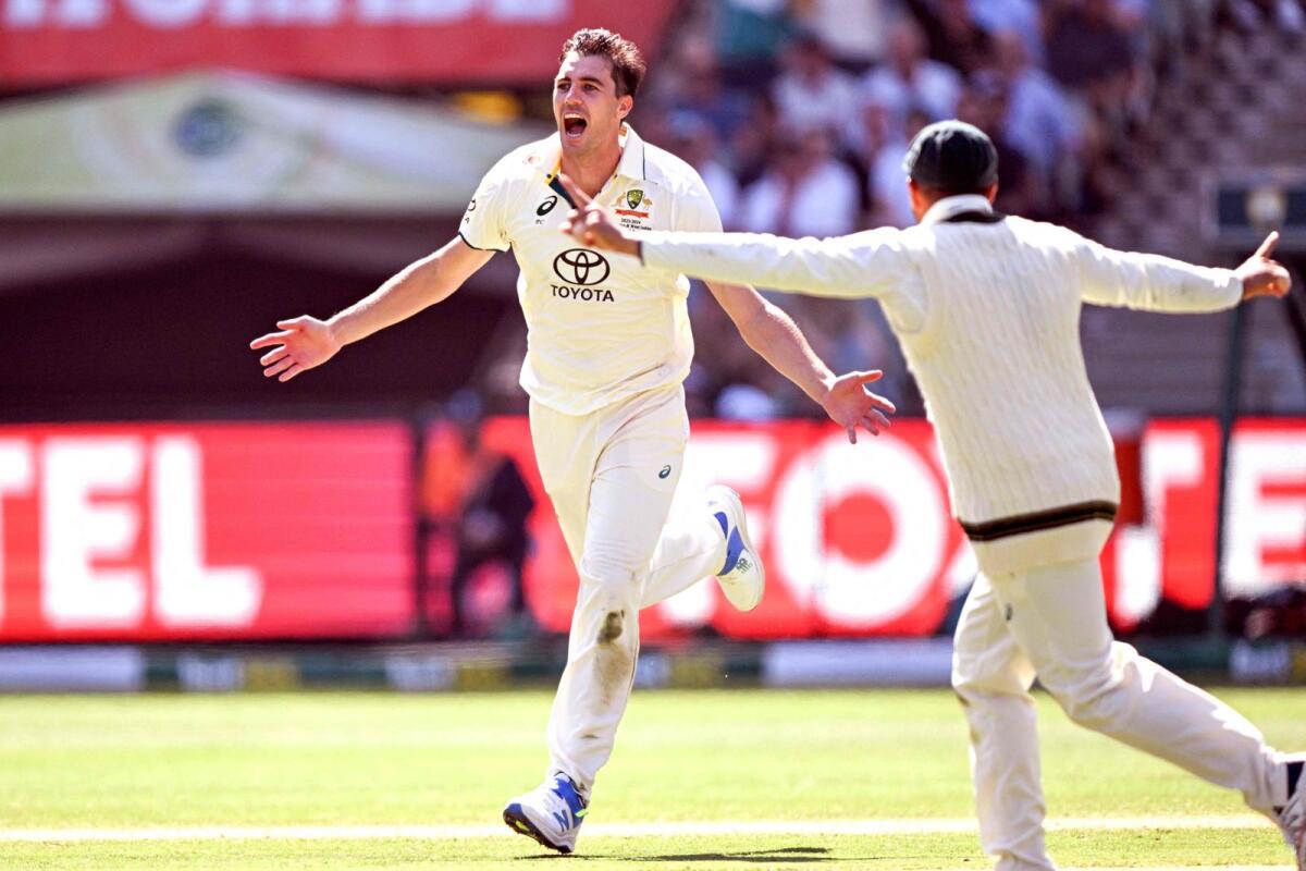 Australia's Pat Cummins celebrates after dismissing Pakistan batsman Babar Azam. — AFP