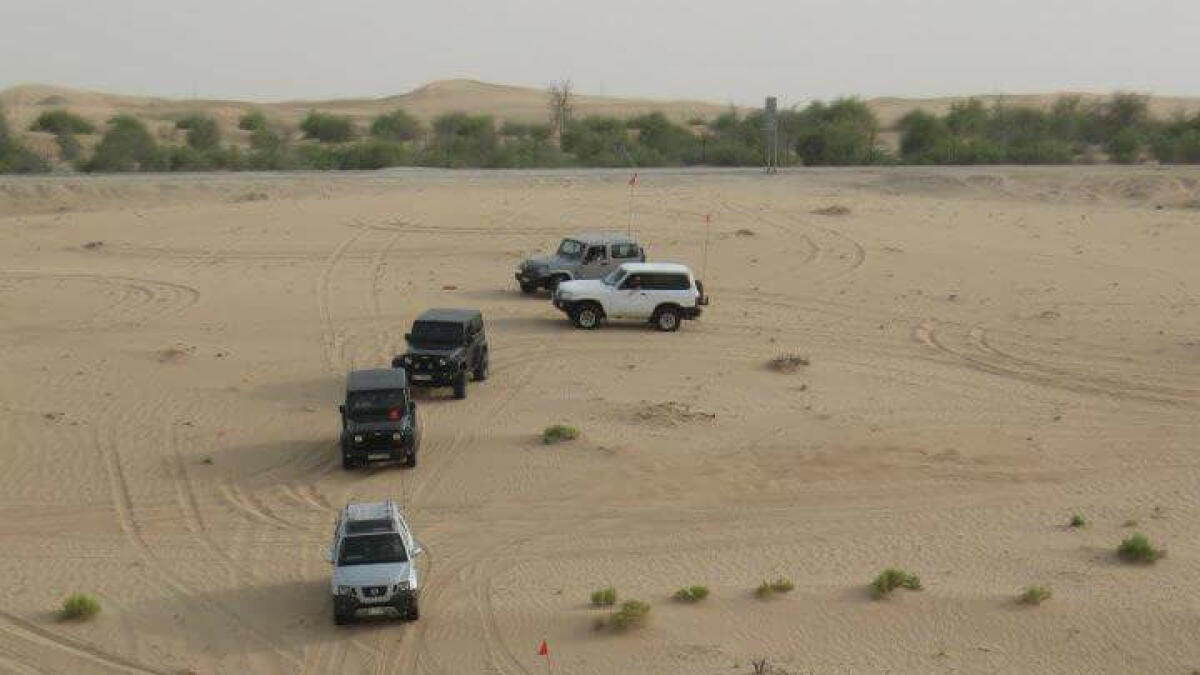 IFTAR IN THE DESERT ... The convoy of UAE Offroaders club arrives in an Abu Dhabi desert; and (right) members of the club, who are like family, are all set for Iftar. - Supplied photo