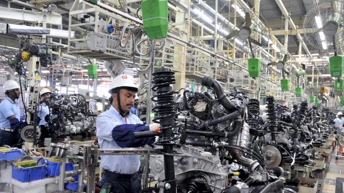 Employee work on the engines of Toyota cars inside the manufacturing plant of Toyota Kirloskar Motor in Bidadi, on the outskirts of Bengaluru, India. — Reuters file photo 