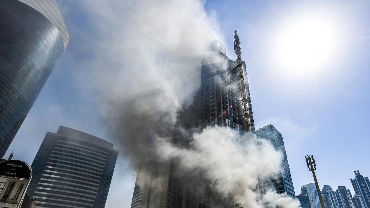 Smoke rising from a fire in a tower in the Business Bay area in Dubai.-AFP 