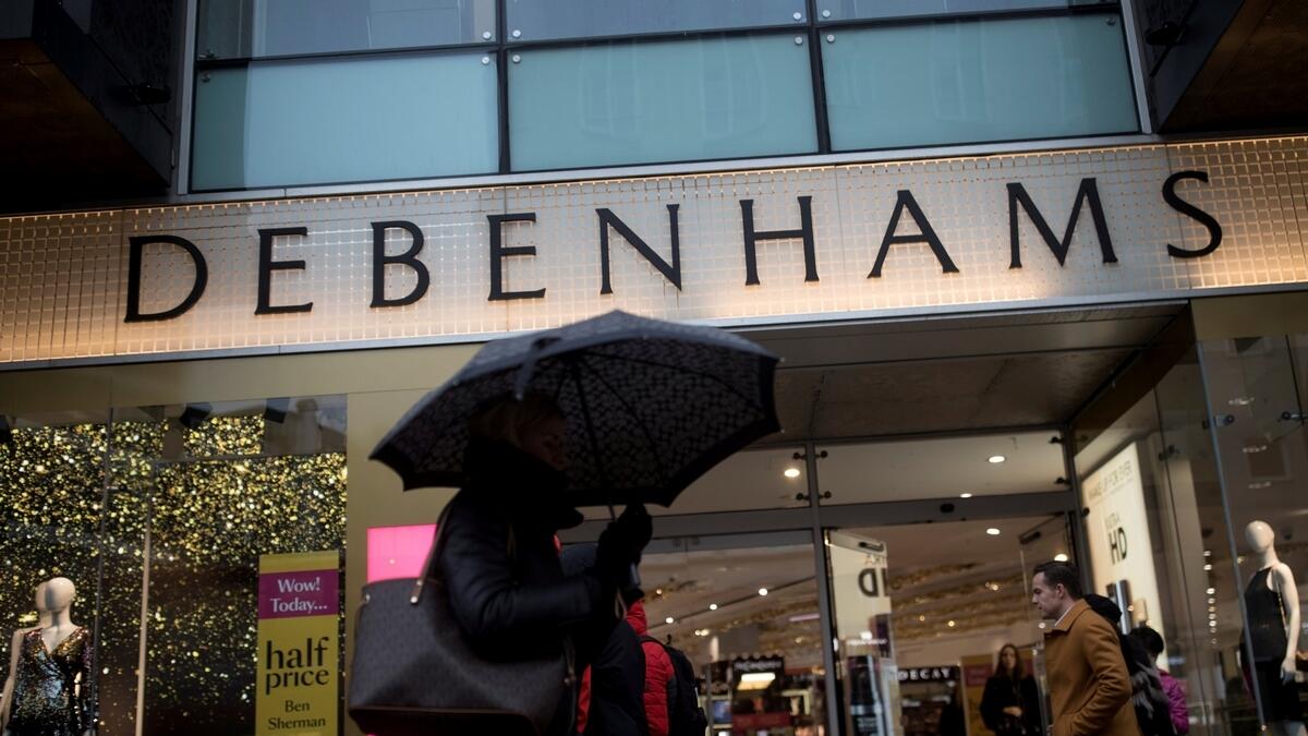 Shoppers walk past the Debenhams department store on Oxford Street in London, Britain.- Reuters