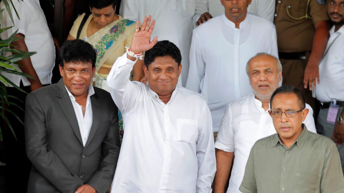 Sajith Premadasa (centre) waves to the crowd in this file photo. –AP