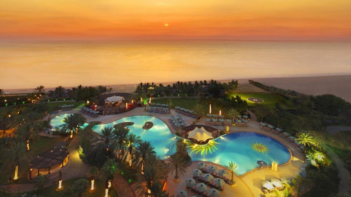 A view of the pool at the Le Meridien Al Aqah Beach Resort Fujairah at sunset