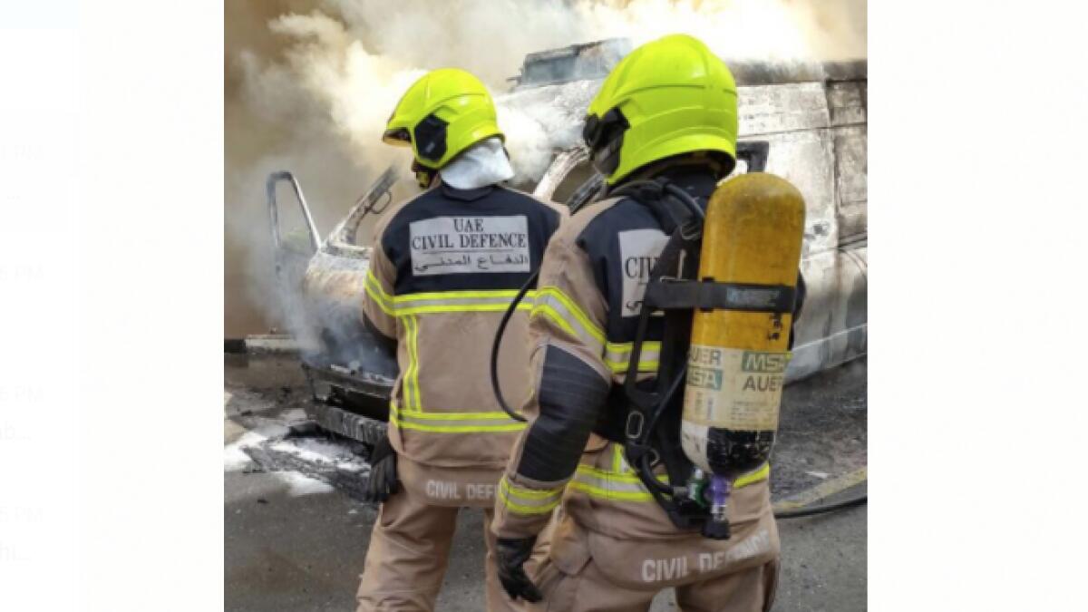 Firefighters from the Dubai Civil Defence work on putting out the fire
