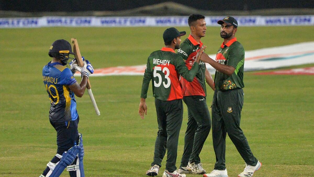 Bangladesh's Mohammad Saifuddin (second right) celebrates with teammates after taking the wicket of Sri Lanka's Wanindu Hasaranga. — AFP