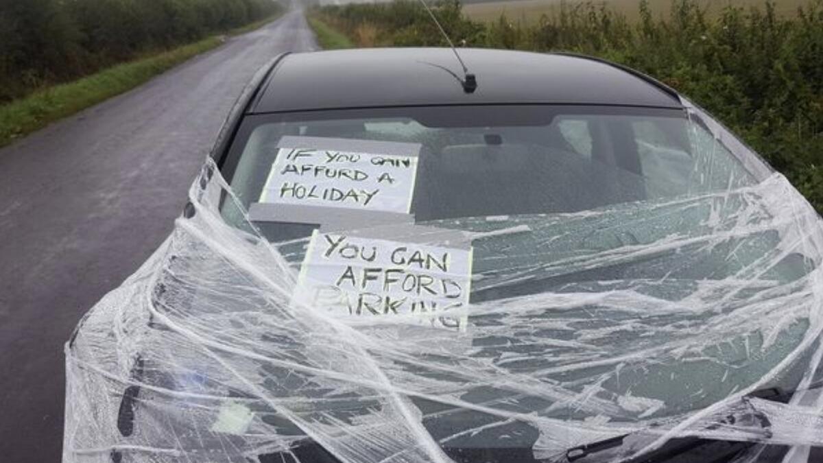 Illegally parked car wrapped in clingfilm, lashed with eggs