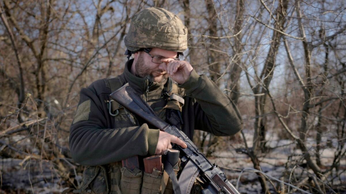 A Ukrainian serviceman adjusts his glasses at a frontline position, outside Popasna, Luhansk region, eastern Ukraine. — AP
