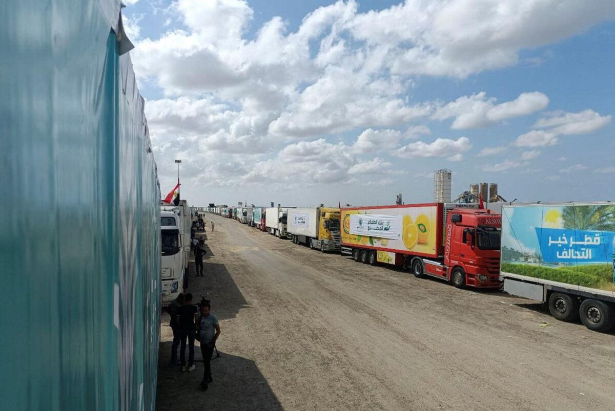 Trucks carrying humanitarian aid from Egyptian NGOs for Palestinians wait for the reopening of the Rafah crossing at the Egyptian side, to enter Gaza. Photo: Reuters