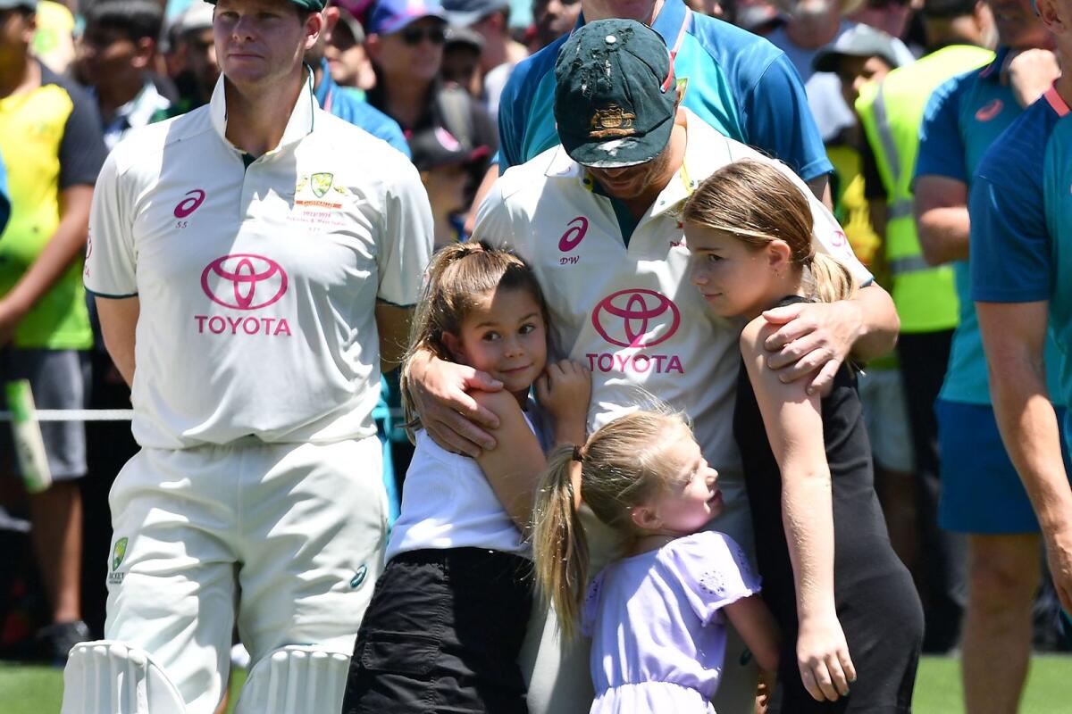 Australia’s David Warner hugs his daughters after his farewell Test o at the Sydney Cricket Ground. - AFP