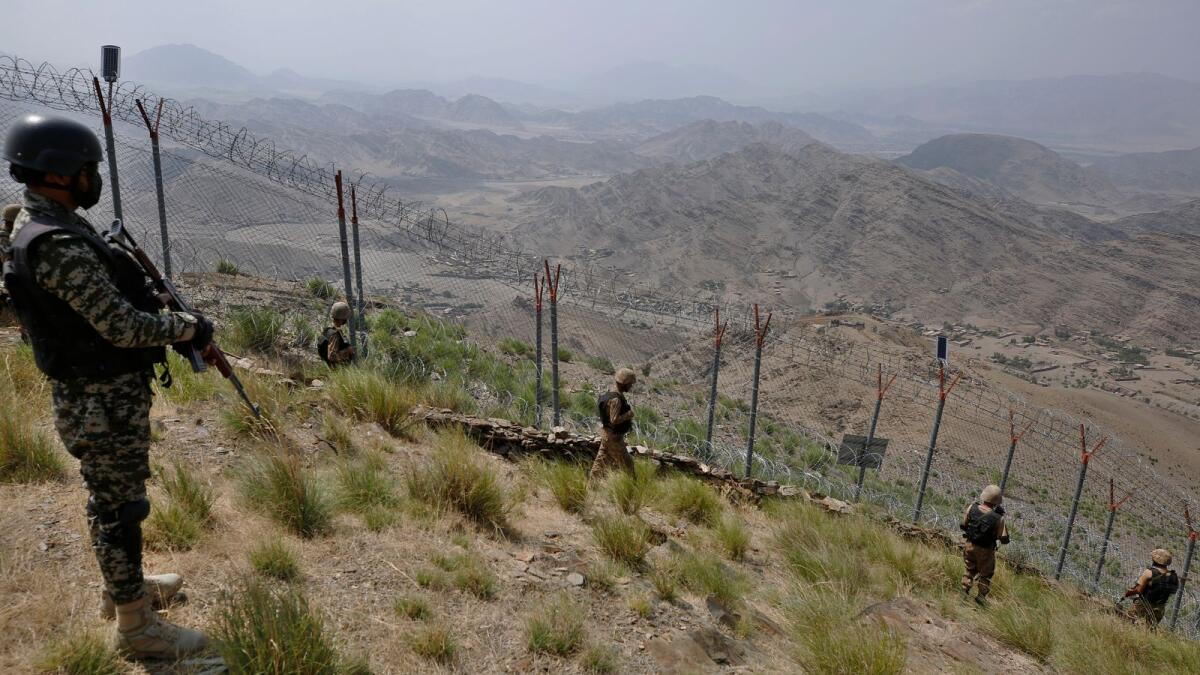 Pakistan Army troops patrol along the fence on the border. – AP