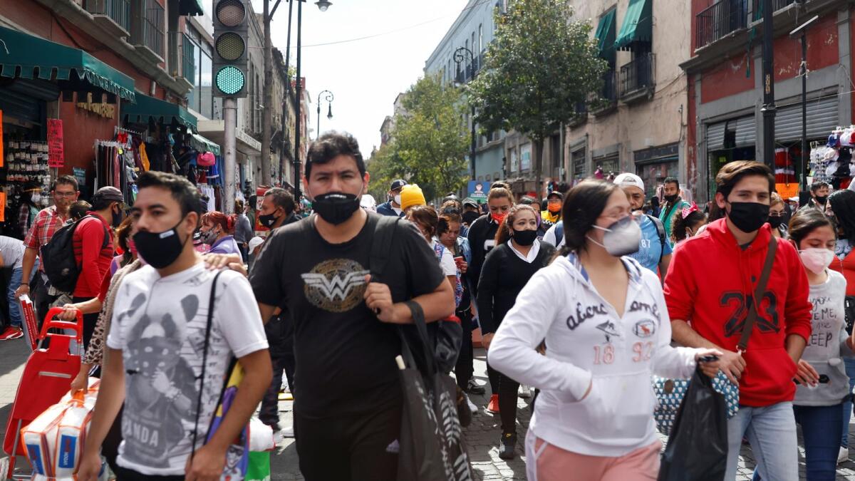 People are seen on the street as the coronavirus disease (COVID-19) outbreak continues in Mexico City, Mexico December 4, 2020.