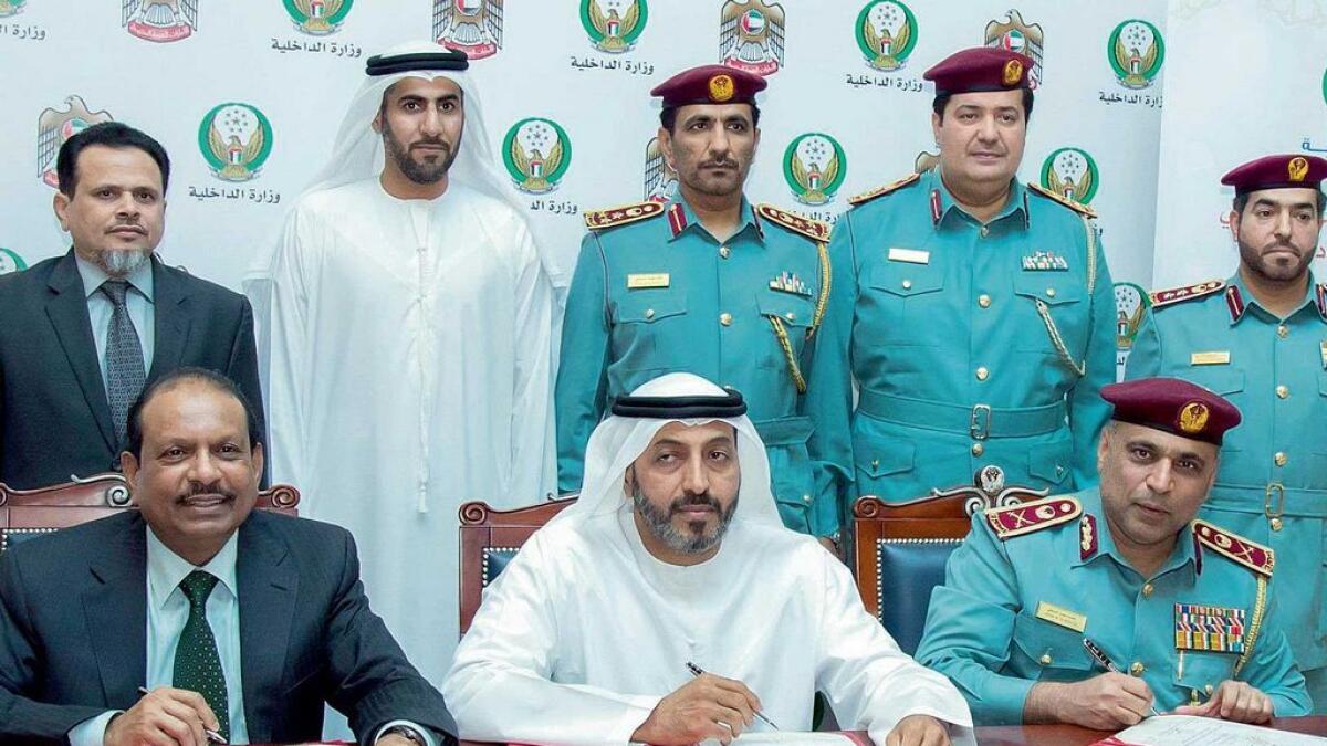 Maj-Gen Jassim Mohammed Al Marzouki, Dr Mohammed Matar Al Kaabi and Yusufali M.A during the signing ceremony for providing fire extinguishers to Abu Dhabi mosques, at the Ministry of Interior headquarters. 