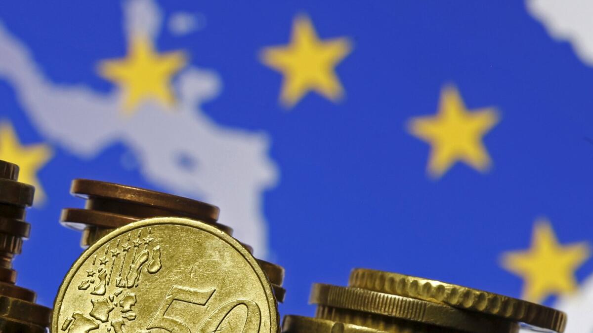 Euro coins are seen in front of displayed flag and map of European Union in this picture illustration taken in Zenica, May 28 2015. The president of the European Central Bank called on euro zone countries to reform their economies, warning that future growth, in the face of entrenched unemployment and low investment, will be modest.  REUTERS/Dado Ruvic