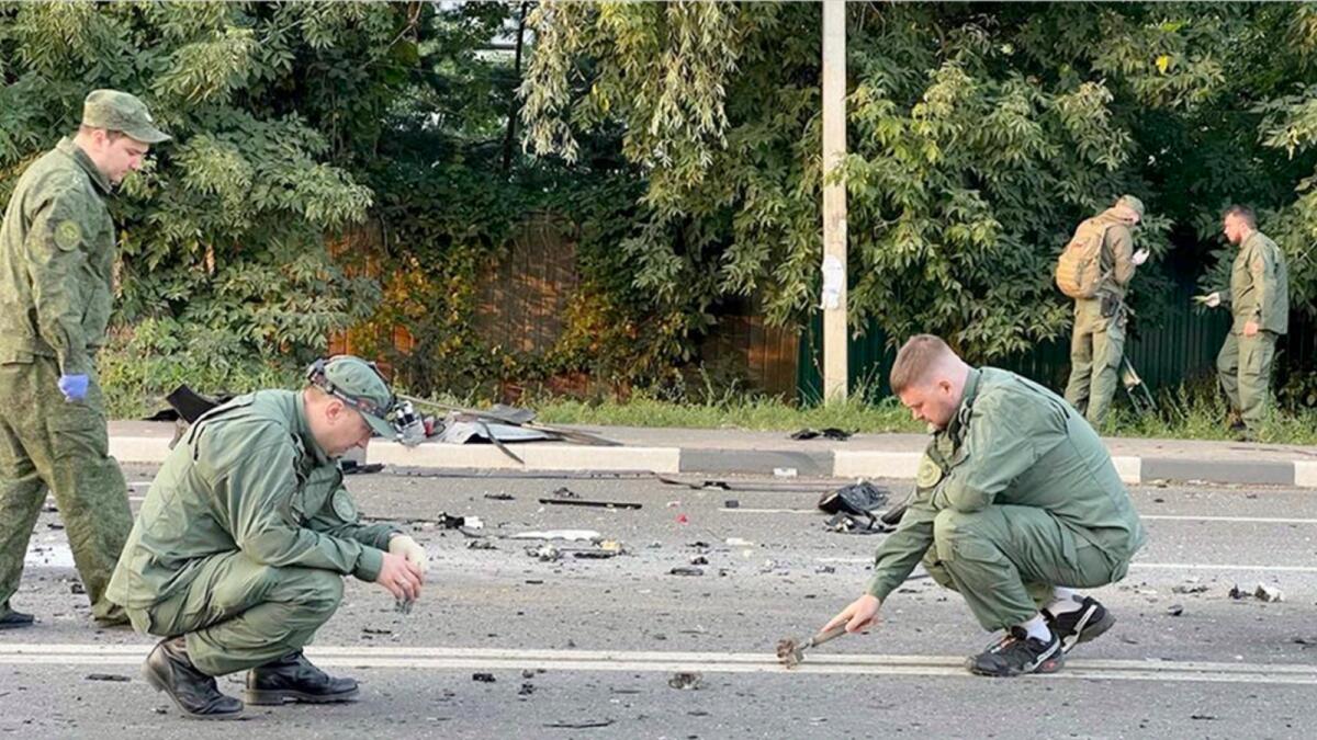 Investigators work on the site of explosion of a car driven by Daria Dugina outside Moscow. — AP