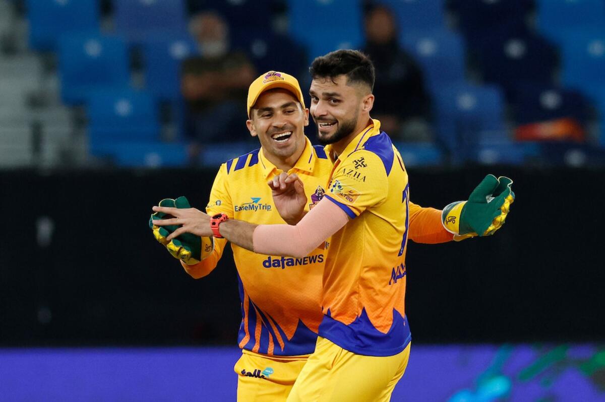 Naveen-ul-Haq (right) of Sharjah Warriors celebrates the wicket of Liam Dawson of Gulf Giants during the match at the Dubai International Stadium. — Supplied photo