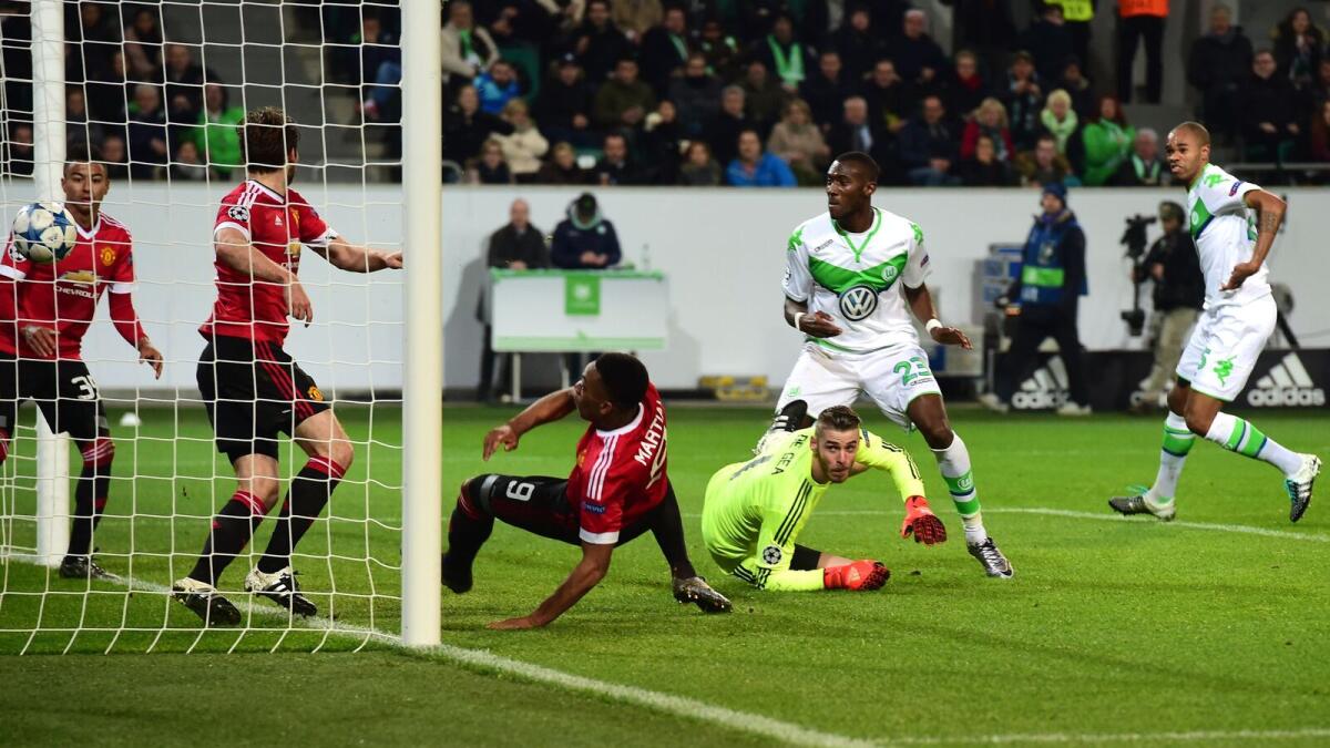 Wolfsburg’s Naldo (right) scores against Manchester United during the Champions League match. 