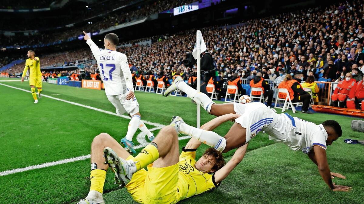 Chelsea's Marcos Alonso and Real Madrid's Rodrygo tumble off the pitch during the match. — Reuters