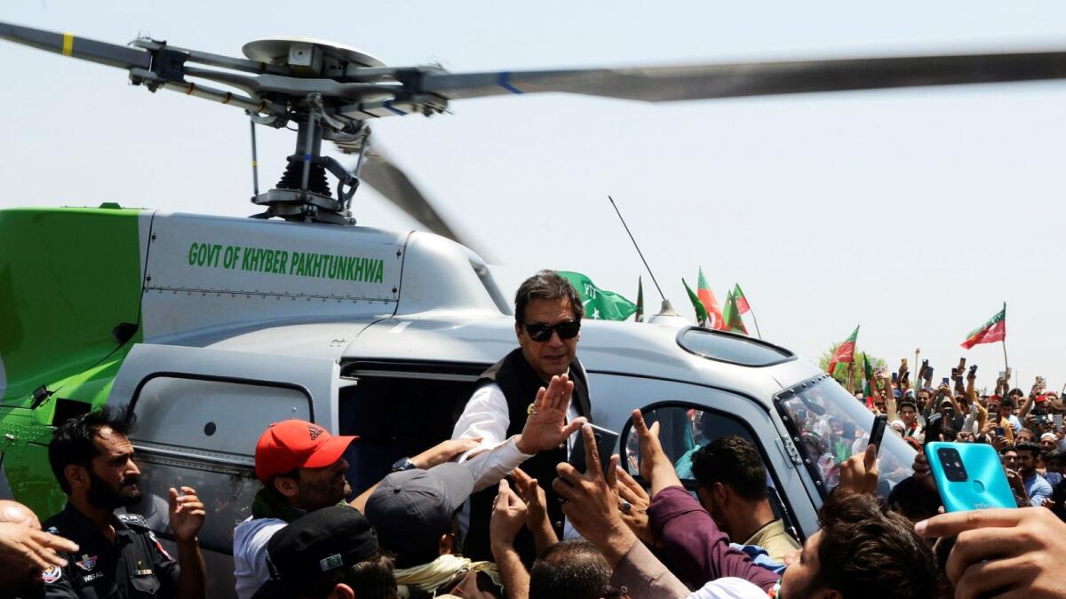 Pakistan's ousted prime minister Imran Khan waves to suporters upon arriving on a helicopter to lead a protest rally in Swabai on May 25, 2022. (Photo: AFP)