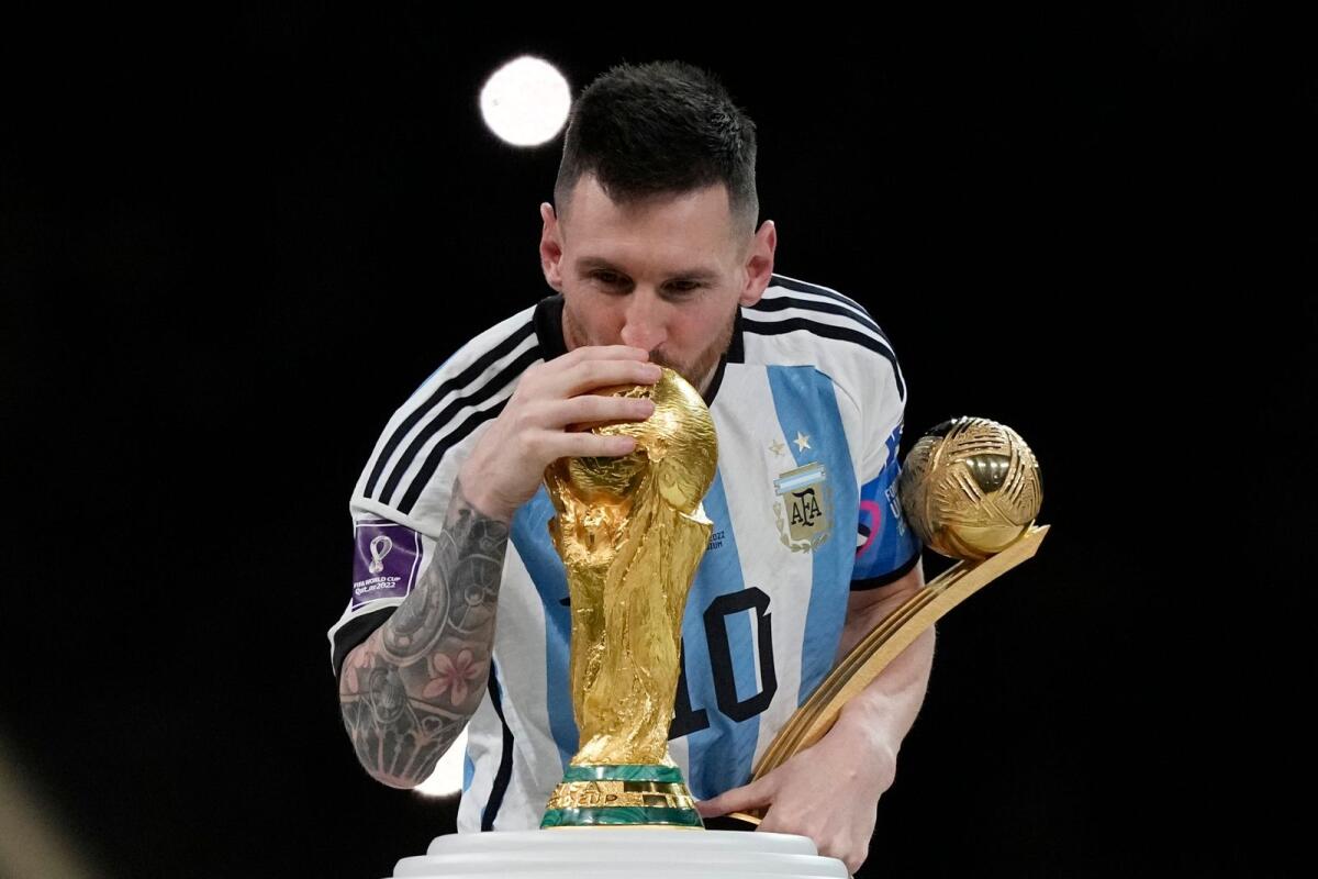 Argentina's Lionel Messi kisses the trophy after winning the World Cup final. (AP)