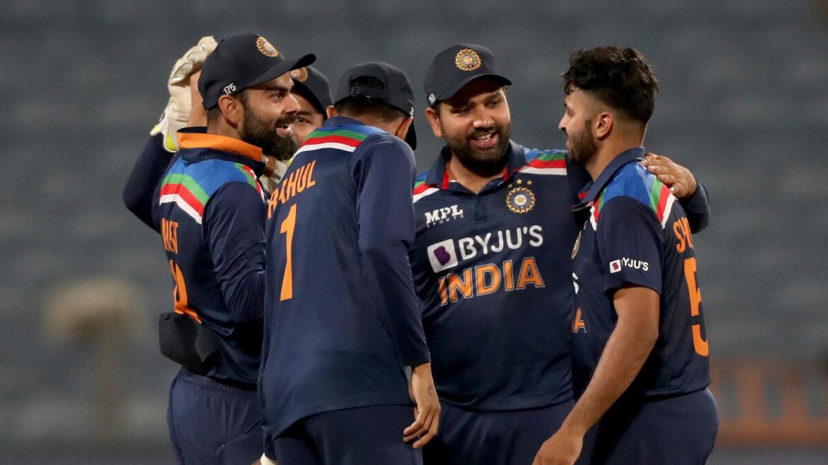 Indian players celebrate the dismissal of England's Adil Rashid. — AP