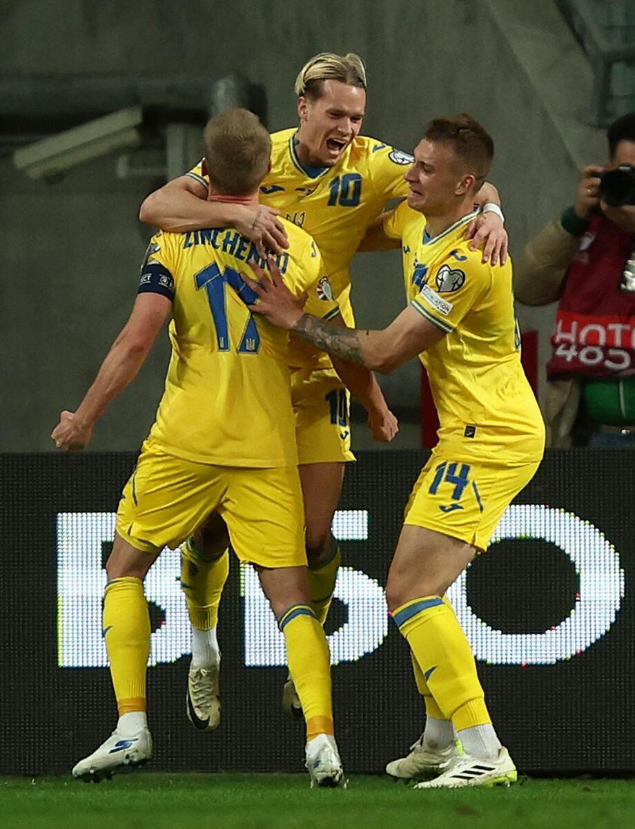 Ukraine's Mykhailo Mudryk celebrates scoring their second goal with Oleksandr Zinchenko and Volodymyr Brazhko. — Reuters