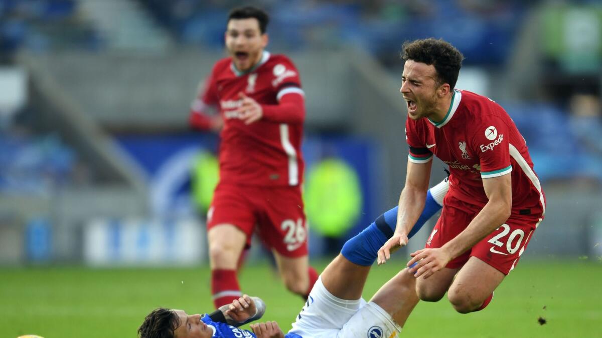 Brighton's defender Ben White tackles Liverpool's striker Diogo Jota (right) during the English Premier League match. (AFP)