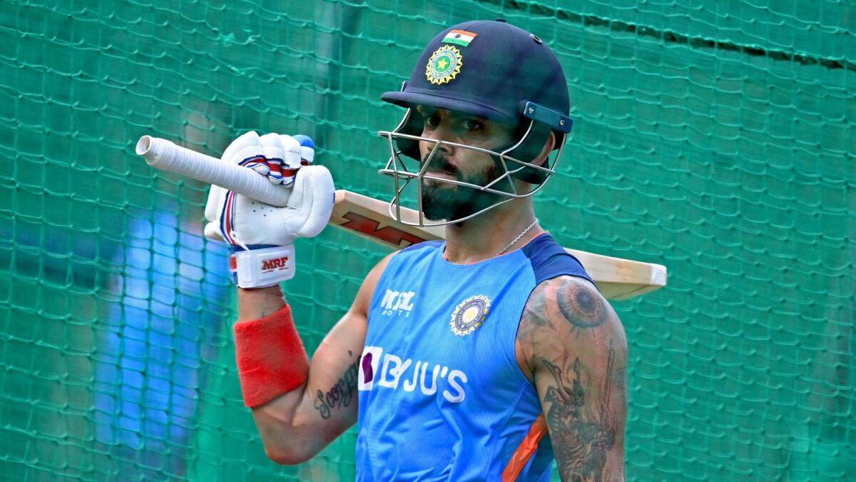 India's Virat Kohli arrives to bat in nets during a practice session at the Punjab Cricket Association Stadium in Mohali on Sunday. (AFP)