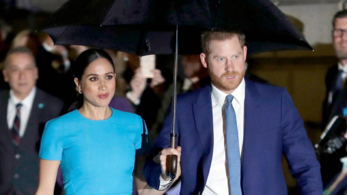 Prince Harry with wife Meghan. — AP file