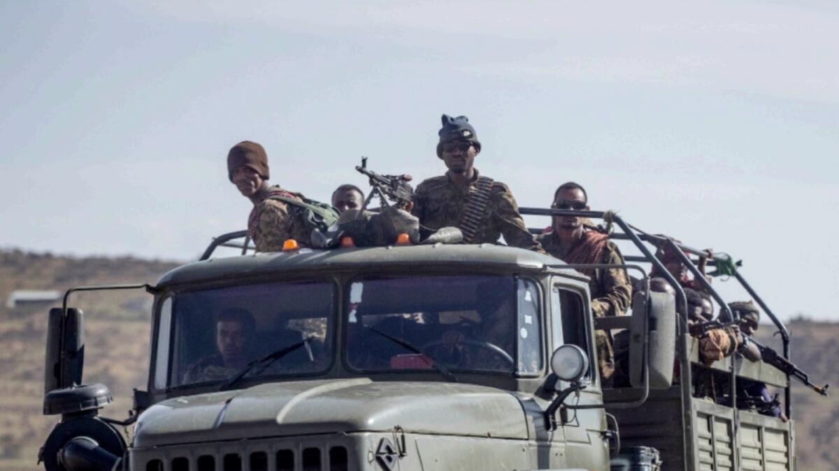 Ethiopian government soldiers ride in the back of a truck on a road near Agula, north of Mekele, in the Tigray region. — AP file