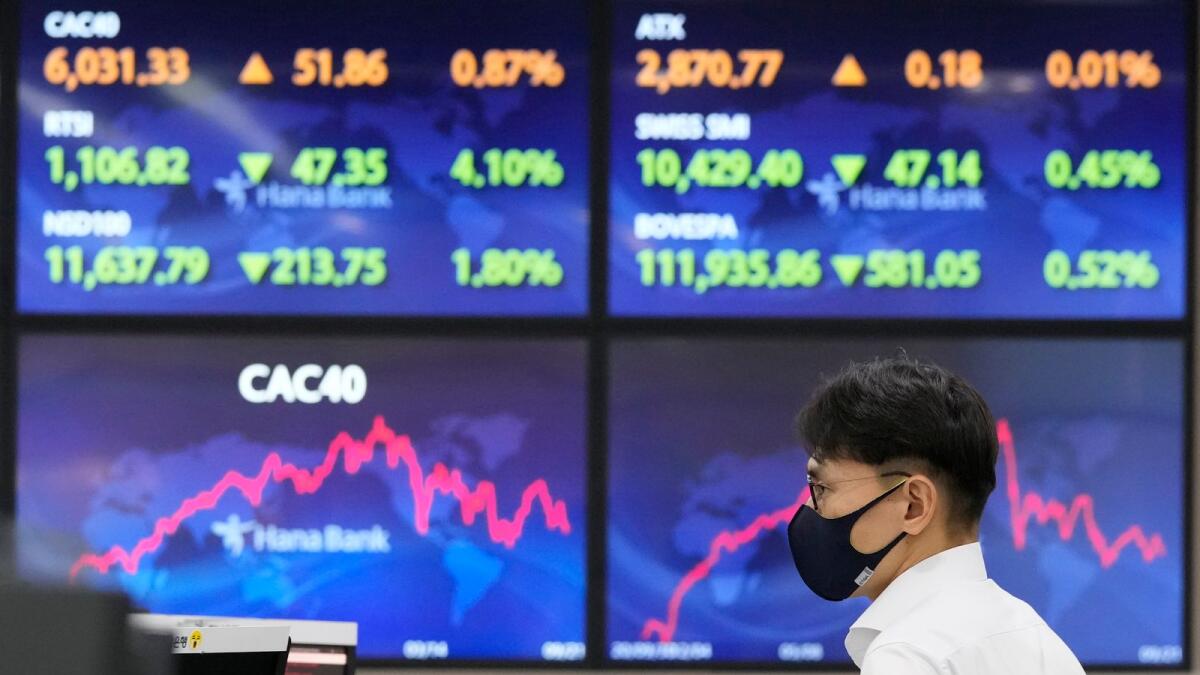 A currency trader watches monitors at the foreign exchange dealing room of the KEB Hana Bank headquarters in Seoul, South Korea, on September 22, 2022. Asian stock markets followed Wall Street lower on Thursday after the Federal Reserve delivered another big interest rate hike to cool galloping inflation and raised its outlook for more. — AP