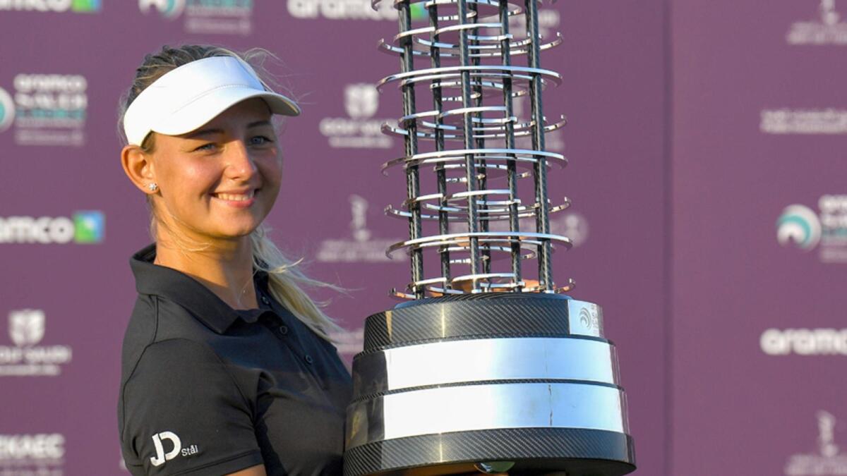Emily Pedersen celebrates with the trophy after winning the Saudi Ladies International golf tournament on Sunday. — AFP
