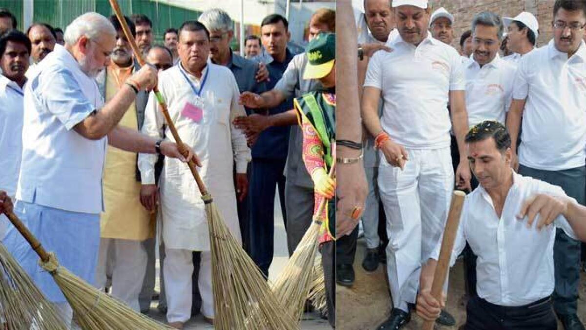 Prime Minister Narendra Modi launched the Swachh Bharat Mission by sweeping a street at a residential colony in New Delhi (left) and Akshay Kumar take part in cleanliness drive during the Swachh Bharat Mission in Maheshwar near Indore (right)