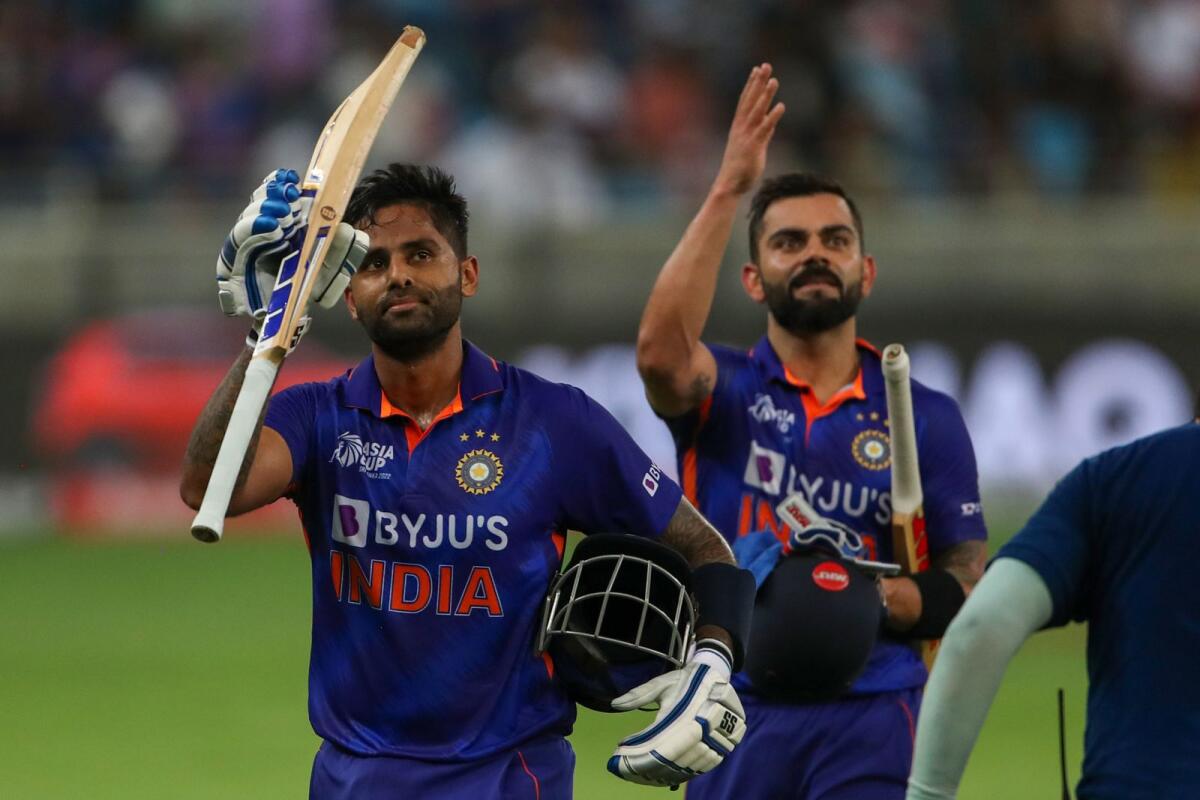 India's Virat Kohli (right) and his teammate Suryakumar Yadav leave the field after their innings during the Asia Cup match against Hong Kong at the Dubai International Cricket Stadium. (AFP)