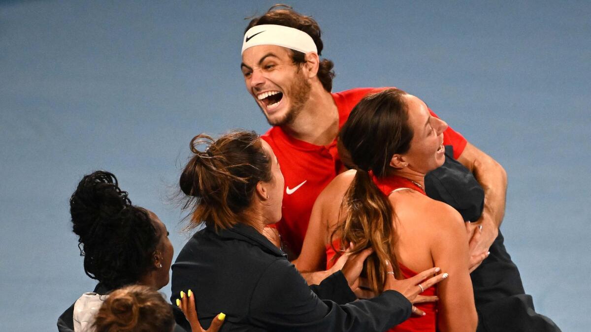 Taylor Fritz (centre) of the US celebrates victory against Italy's Matteo Berrettini. — AFP