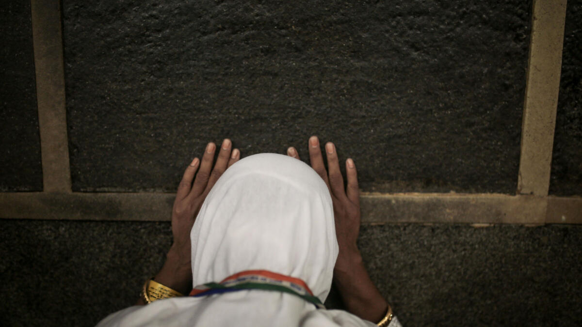 In this Monday, Sept. 21, 2015 photo, a Muslim pilgrim prays at the Kaaba, the cubic building at the Grand Mosque