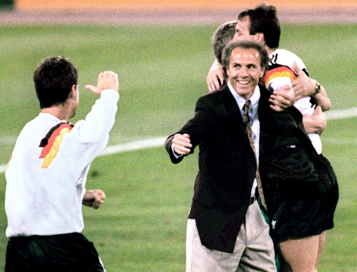 Head coach Franz Beckenbauer (centre) celebrates after West Germany won the 1990 World Cup final. — AFP