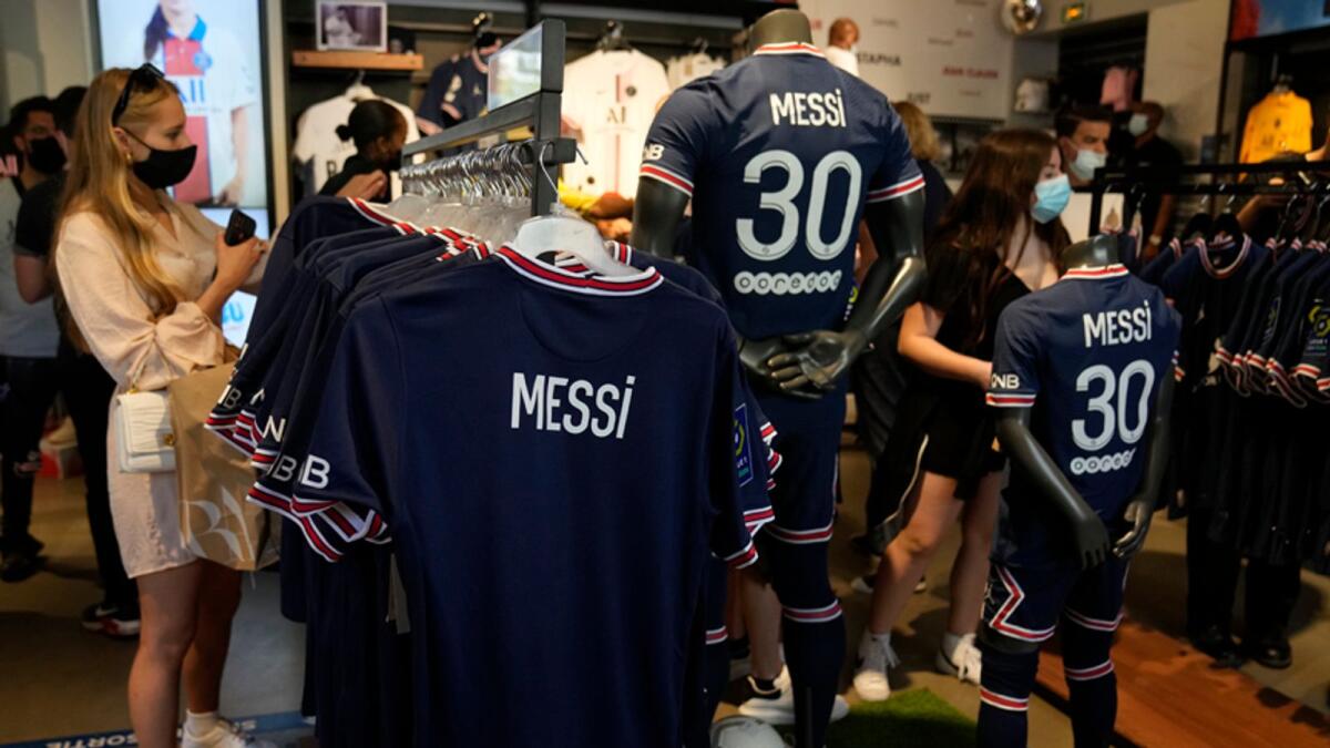 Jerseys bearing the name of Lionel Messi hang in the official PSG shop on Wednesday, in Paris. — AP