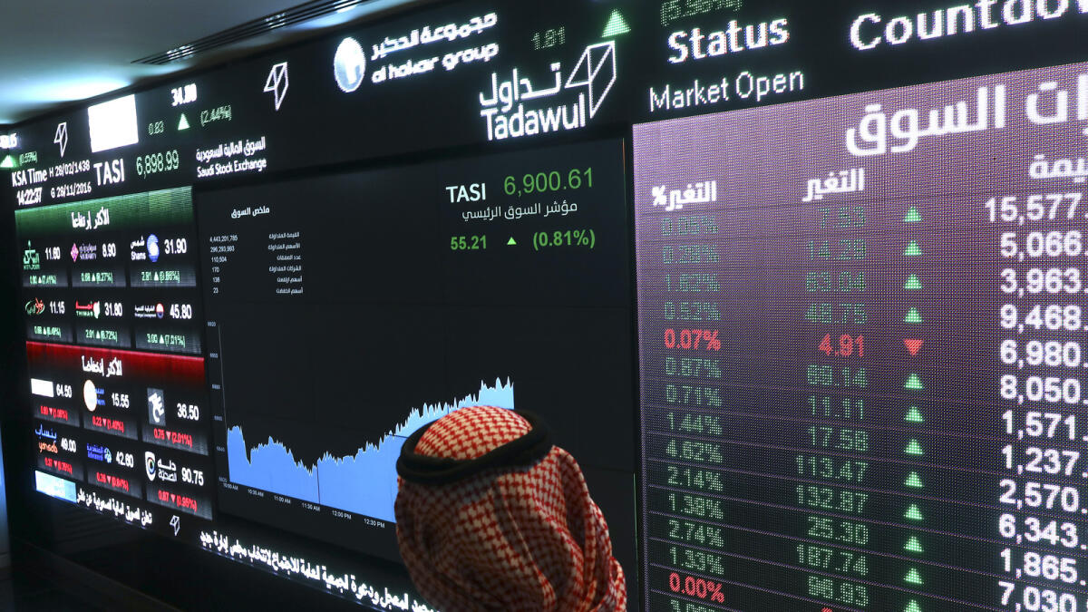A visitor watches stock movements at the Saudi Stock Exchange. — AFP file