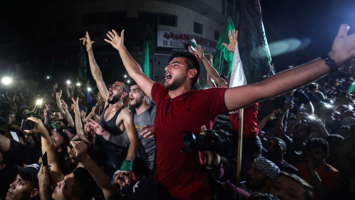 People take to the streets to celebrate following a ceasefire between Israel and Hamas. Photo: AFP