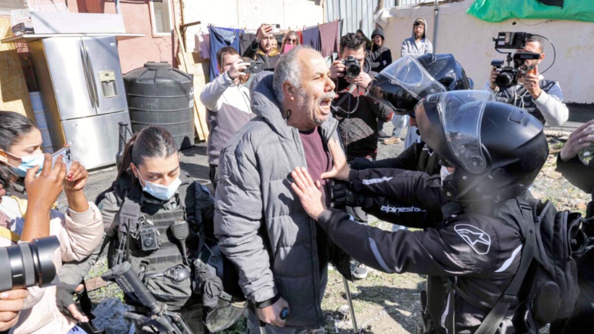 A Palestinian man confronts Israeli security forces in the east Jerusalem neighbourhood of Sheikh Jarrah. — AFP