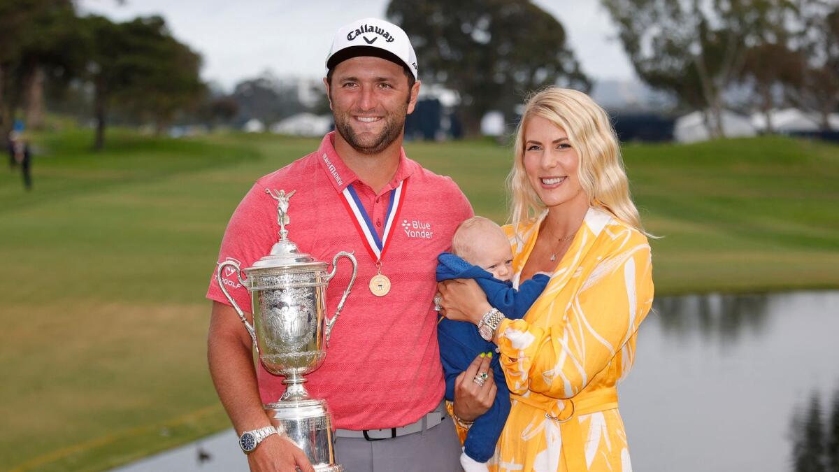 Jon Rahm of Spain celebrates with the trophy alongside his wife, Kelley, and son, Kepa, after winning US Open. (AFP)
