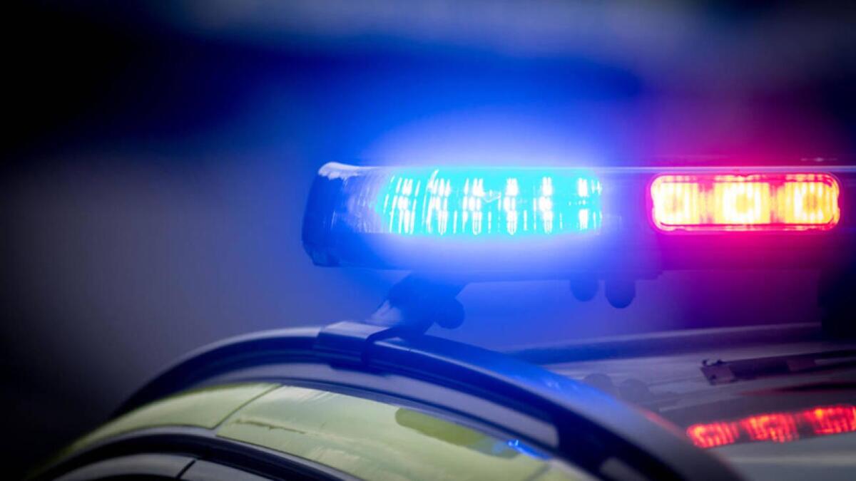 R0JNKR UK Police car lights flashing at a crime scene