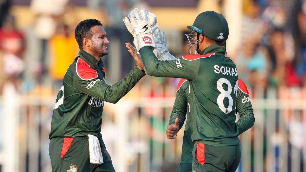 Bangladesh's Shakib Al Hasan (left) is congratulated by teammate Nurul Hasan after taking the wicket of Sri Lanka's Pathum Nissanka. (AP)
