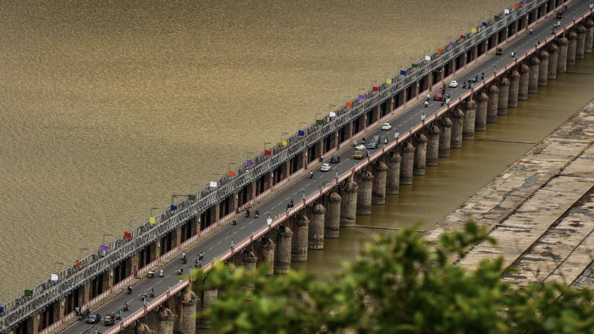 Vehicles ply on the Prakasam Barrage, during Unlock 2.0, in Vijayawada, India. Photo: PTI
