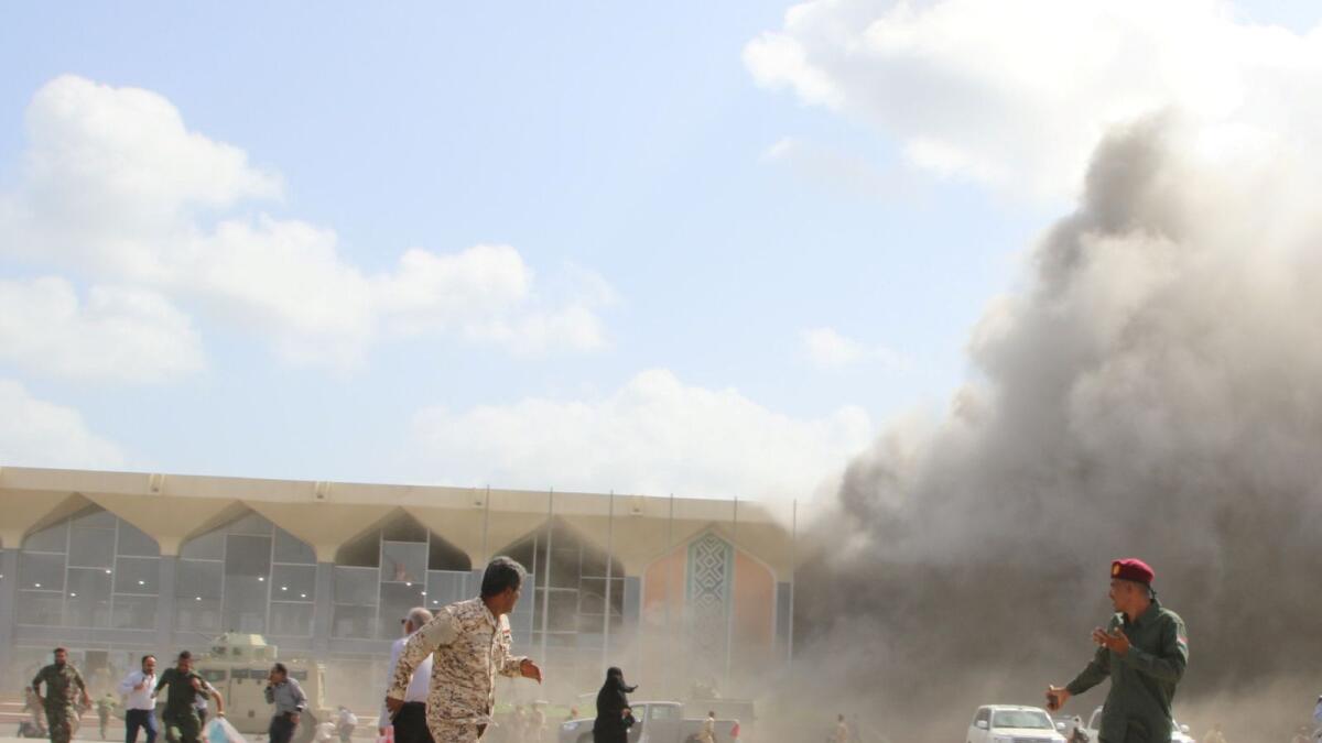 Security personnel and people react during an attack on Aden airport moments after a plane landed carrying a newly formed cabinet for government-held parts of Yemen, in Aden, Yemen December 30, 2020.